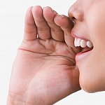 Close-up photo of a woman speaking.