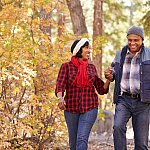 Senior African American couple walking through the woods