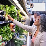 A senior couple picking out fresh produce together at the supermarket