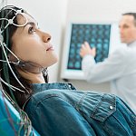 Young woman undergoing electroencephalography