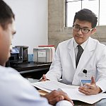 Doctor in consultation with male patient