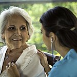 Physician listens to senior patient’s heart