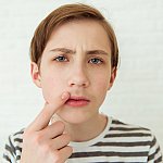 Teenage boy looking at his first mustache in a mirror