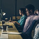 Tired night shift workers in office