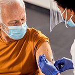 Senior man getting vaccinated at a medical clinic