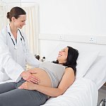 Female doctor with a pregnant woman in an examination room