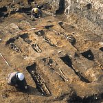 Rows of graves with buried skeletons uncovered 