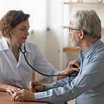 Doctor listening to a patient’s heart with a stethoscope