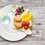 Plate as clock with food between twelve and four.