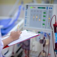 Nurse checking a dialysis machine