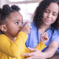 Girl using an asthma inhaler