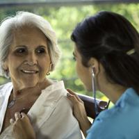 Physician listens to senior patient’s heart