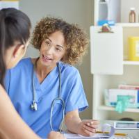 Female doctor talking to woman