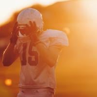 Football player holding helmet