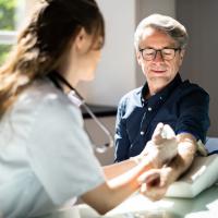 Doctor taking a blood sample from a patient