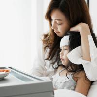 Mother comforting young daughter who refuses to eat