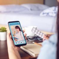 Mobile phone being used for telehealth visit