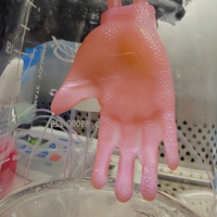 Glove made of bioengineered skin connected to ports for culture infusion in the laboratory