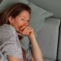 Tired woman lying on sofa.