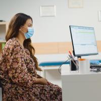 Image of a doctor and patient meeting at a desk.
