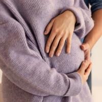 Image of a pregnant woman holding her belly.