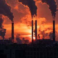  Downloaded Smoke from heating station in big city during winter season at sunset. Smokestack pipes emitting co2 from coal thermal power plant into atmosphere.