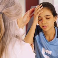 A young soccer player with a head injury recieves medical attention. 