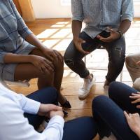Image of people during psychological counseling session sitting indoors