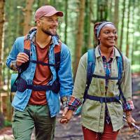 A young couple hiking in the woods.