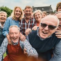 Joyful senior citizens gathered outdoors.
