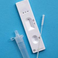 A COVID-19 test kit with a swab and tube on a blue background.