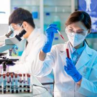 Research technician fills a test tube with blood before the sample is analyzed.