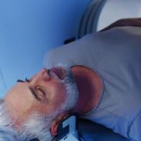 Male patient undergoing CT scan examination in hospital.