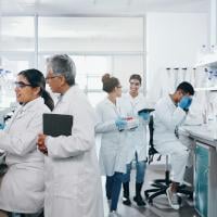 Experiment, science and group of people in laboratory for work on breakthrough, cure or development. Innovation, investigation and research with scientist team in clinical trial for medicine 