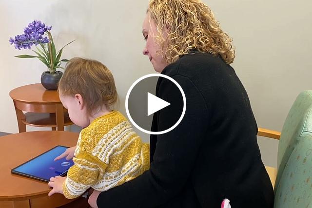 A toddler plays a bubble-popping game as part of a 10-minute app that can greatly aid in screening children for autism. Duke University